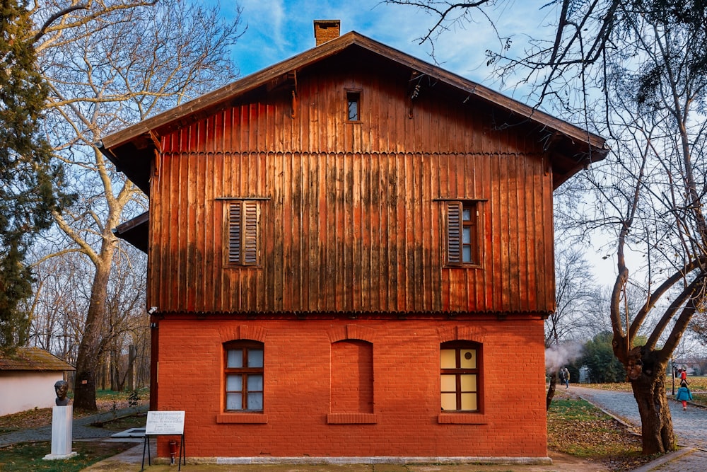 a red brick building with two windows on the side of it