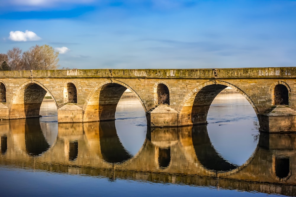 a stone bridge over a body of water