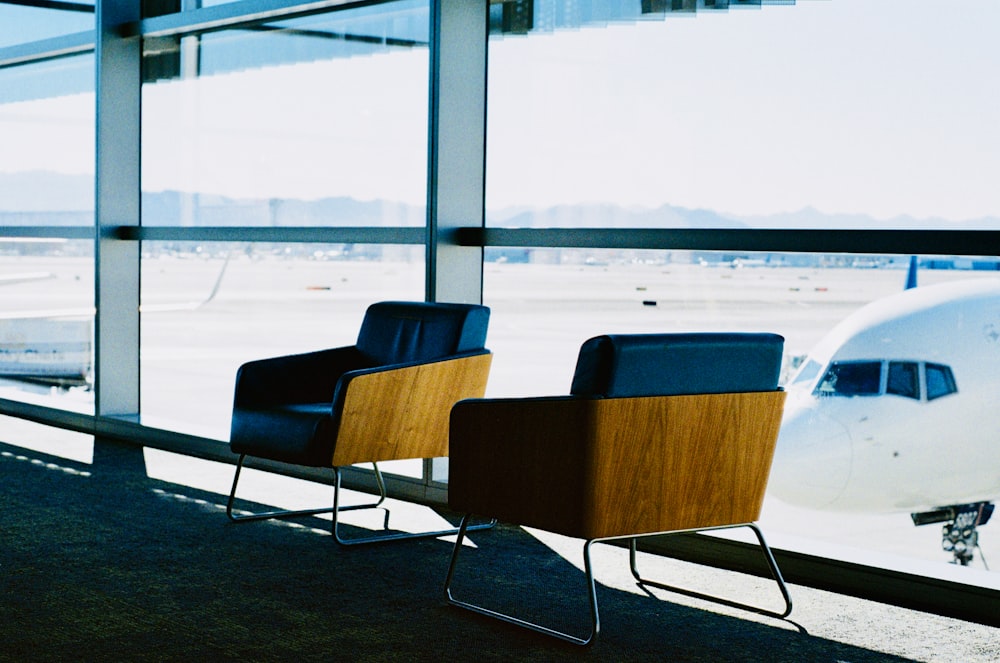 a couple of chairs sitting in front of a window