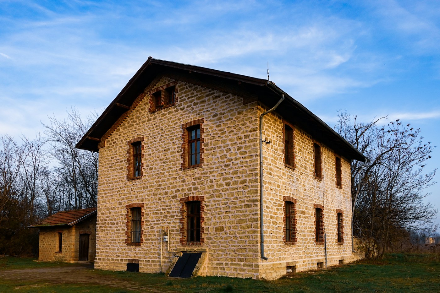 Historic brick and stone building with shutters after restoration