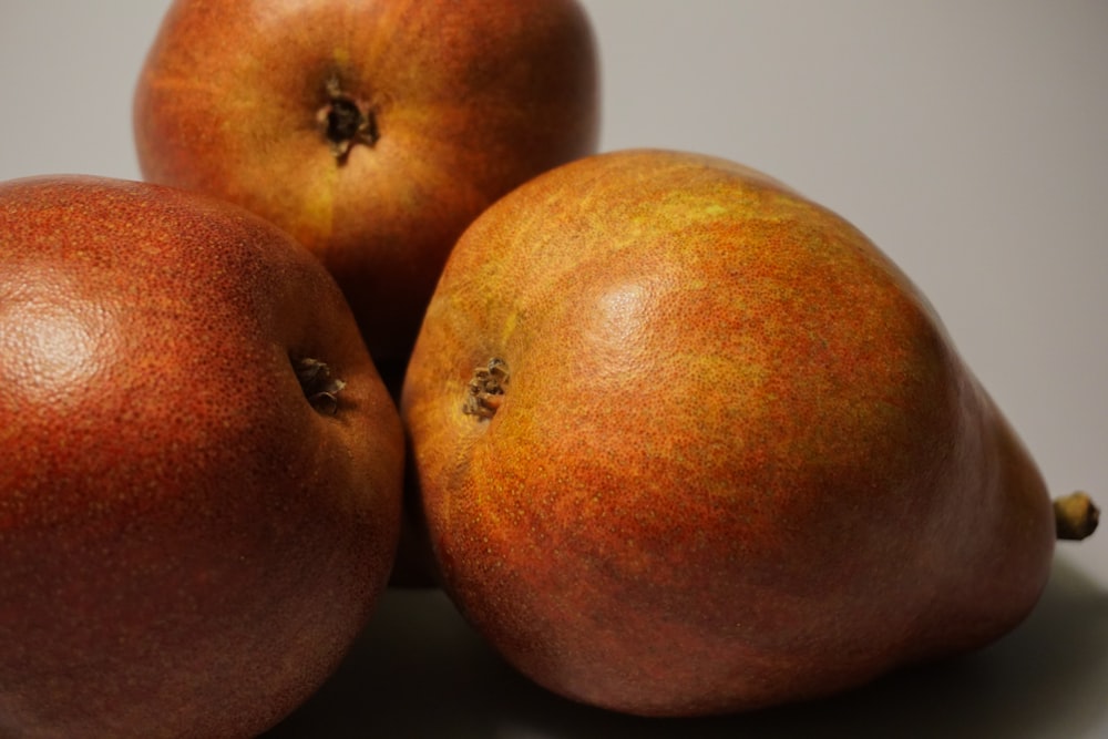 a group of three oranges sitting on top of each other