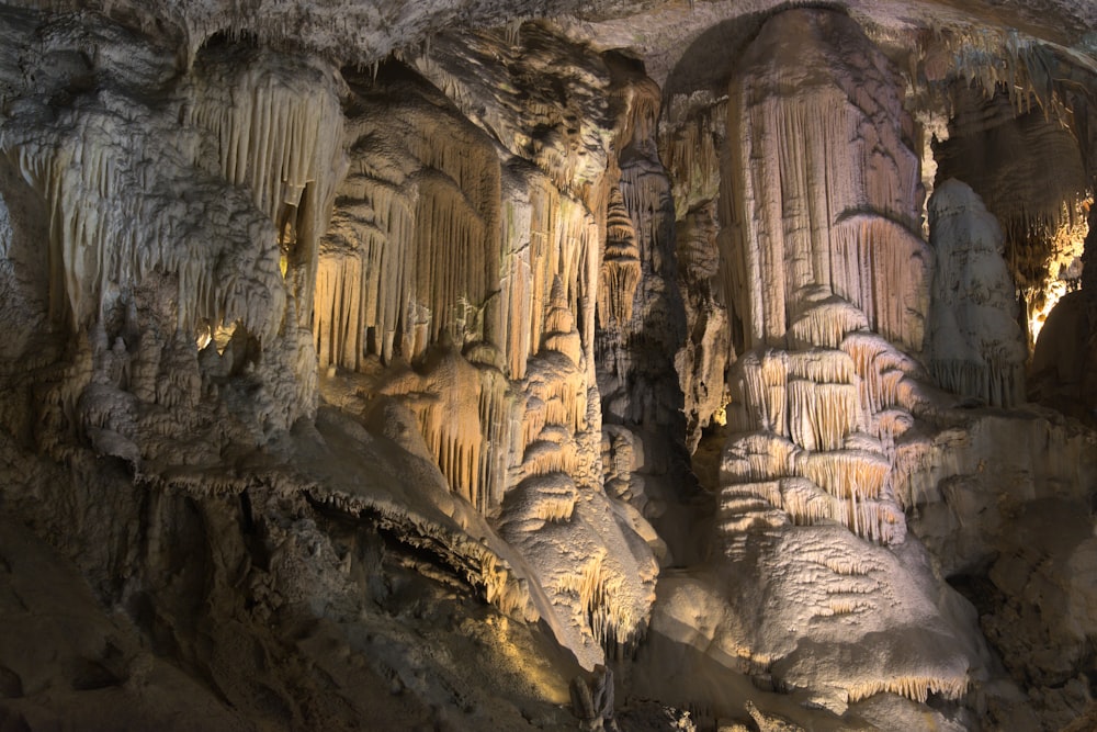 a group of people standing inside of a cave