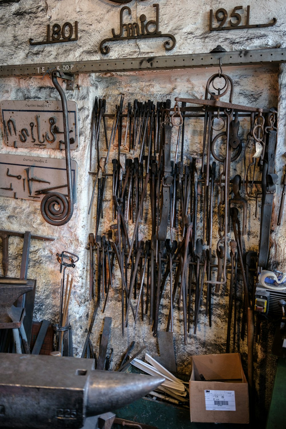 a bunch of tools are hanging on a wall