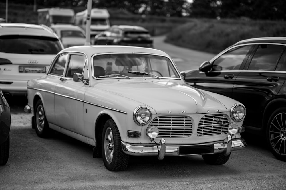 a black and white photo of cars parked in a parking lot