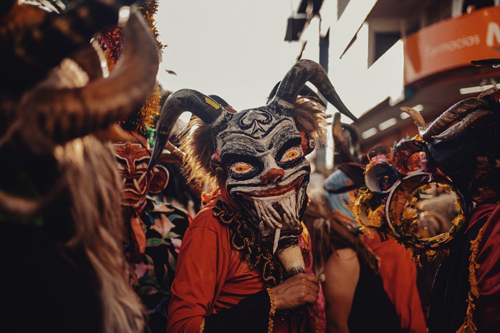 a group of people wearing masks and costumes