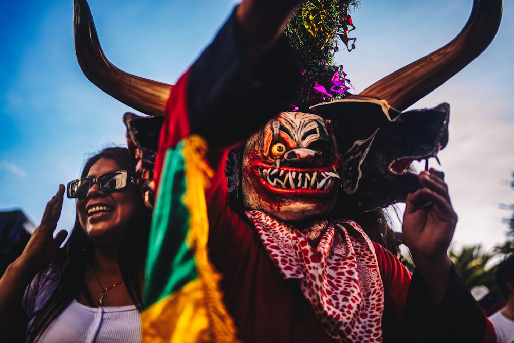 a person wearing a mask with horns on their head