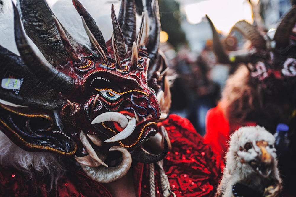 a person wearing a mask with horns and horns