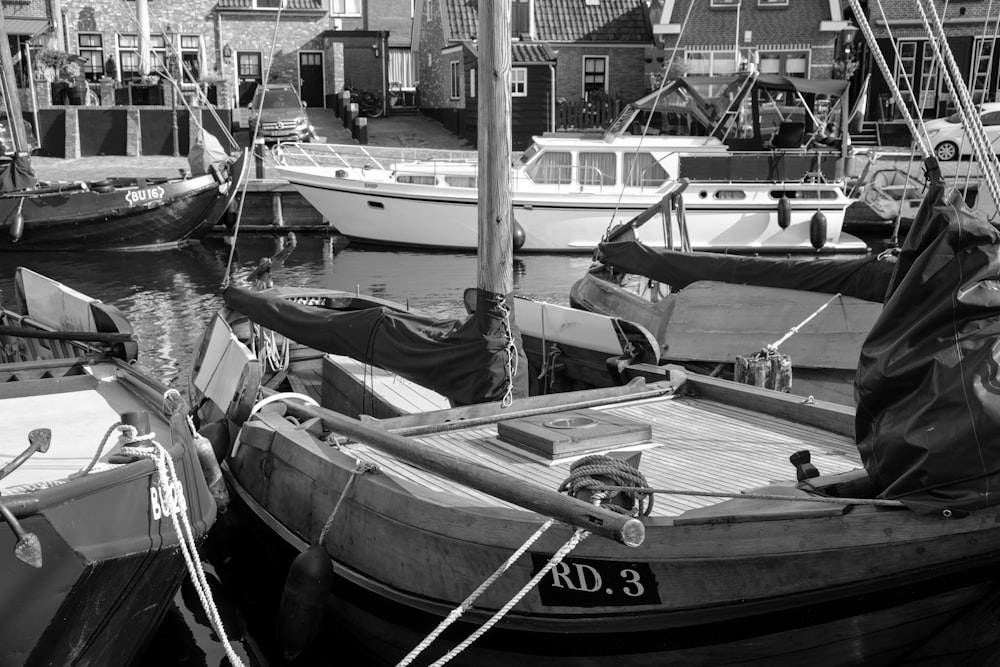 a black and white photo of boats docked in a harbor