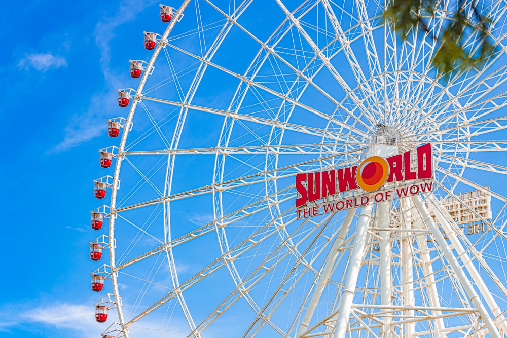 a large white ferris wheel with a sign on it