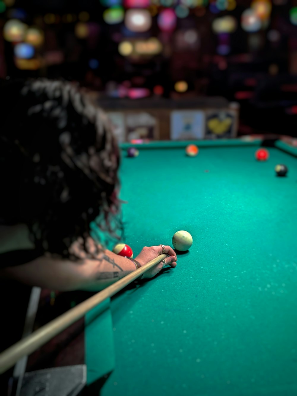 a woman is playing pool on a pool table