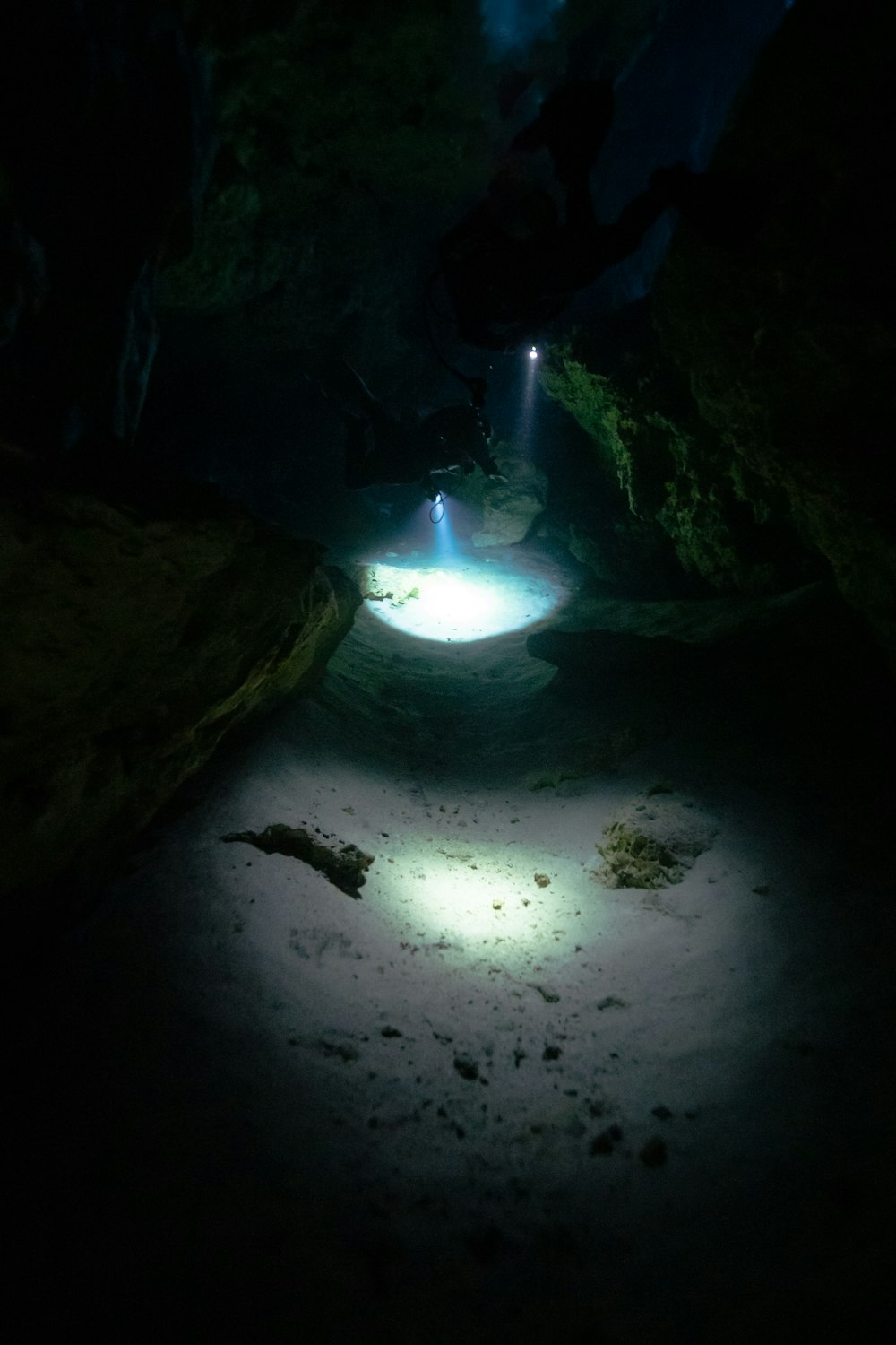 a light shines in the middle of a cave