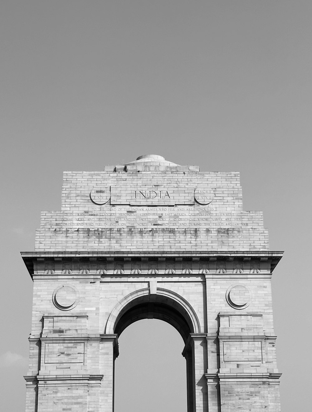 a black and white photo of a stone arch