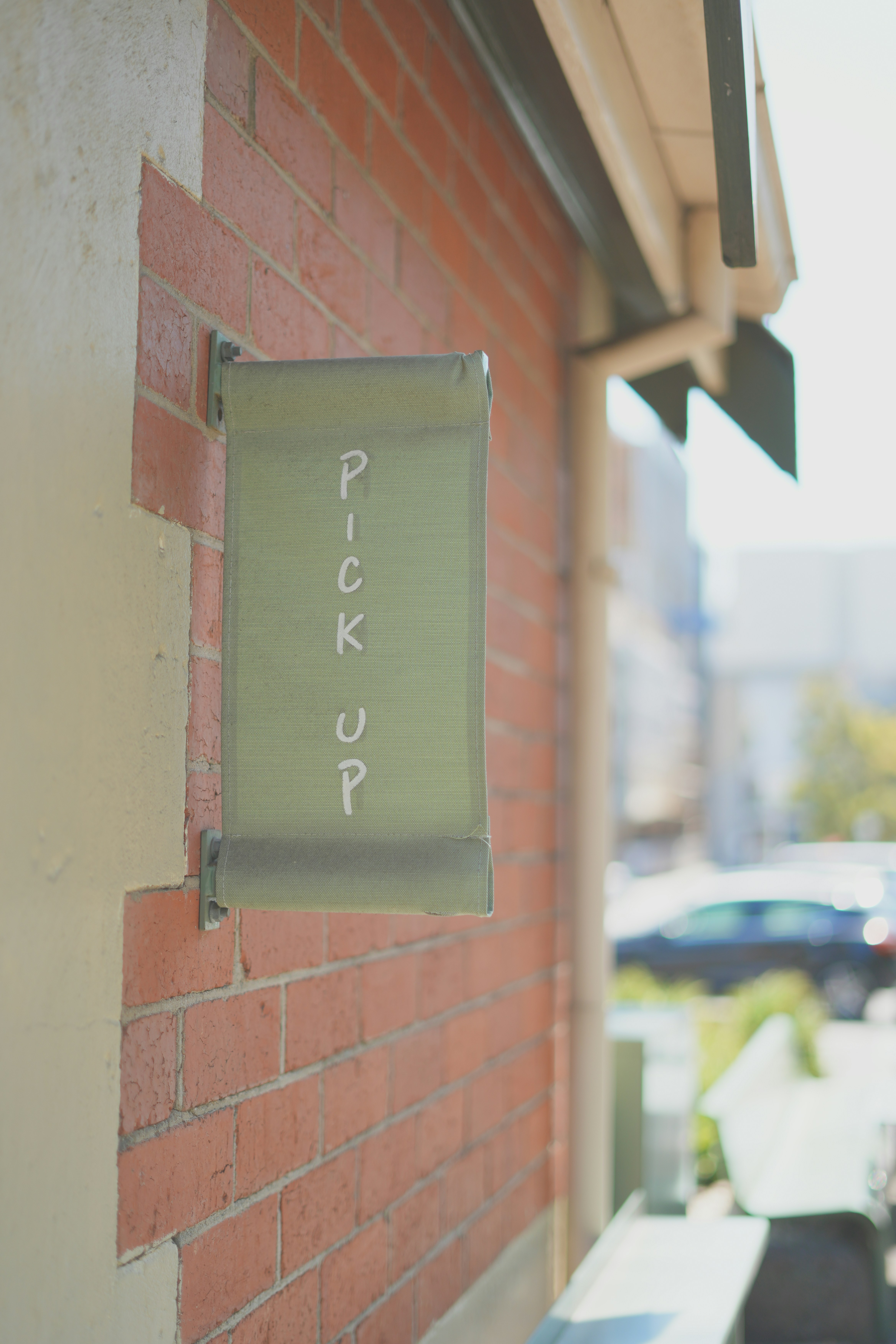 A brick wall with a sign attached to it photo – Free Brick Image on ...