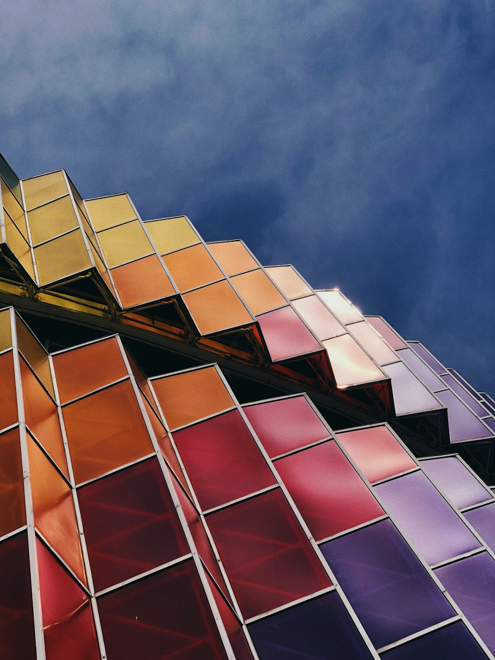a close up of a multicolored building against a blue sky