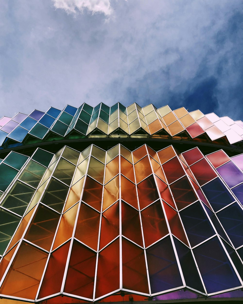a multicolored building with a blue sky in the background