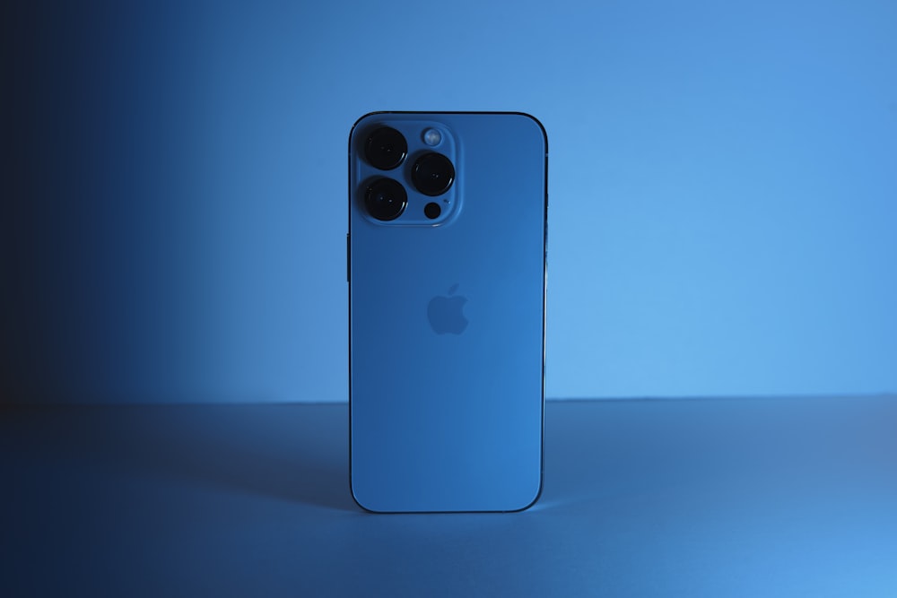 a blue iphone case sitting on top of a table