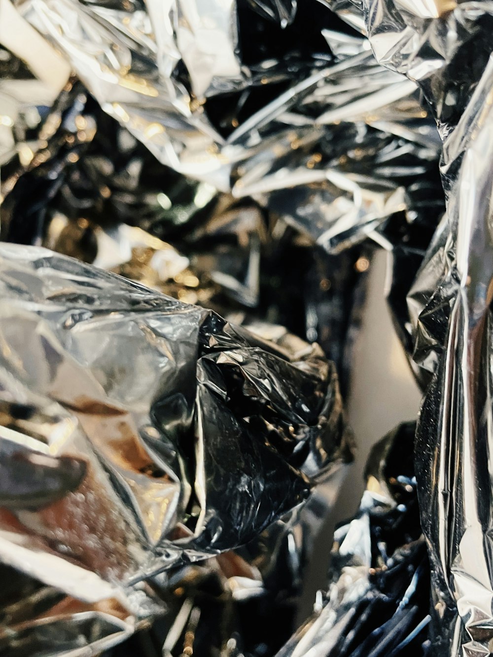 a pile of shiny silver foil sitting on top of a table