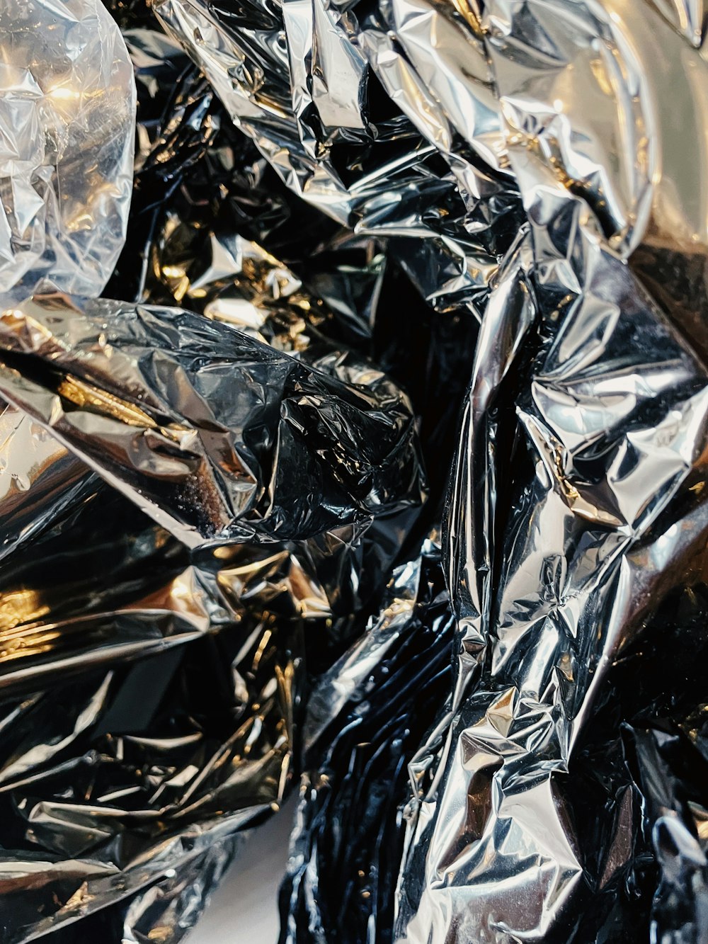 a pile of shiny foil sitting on top of a table