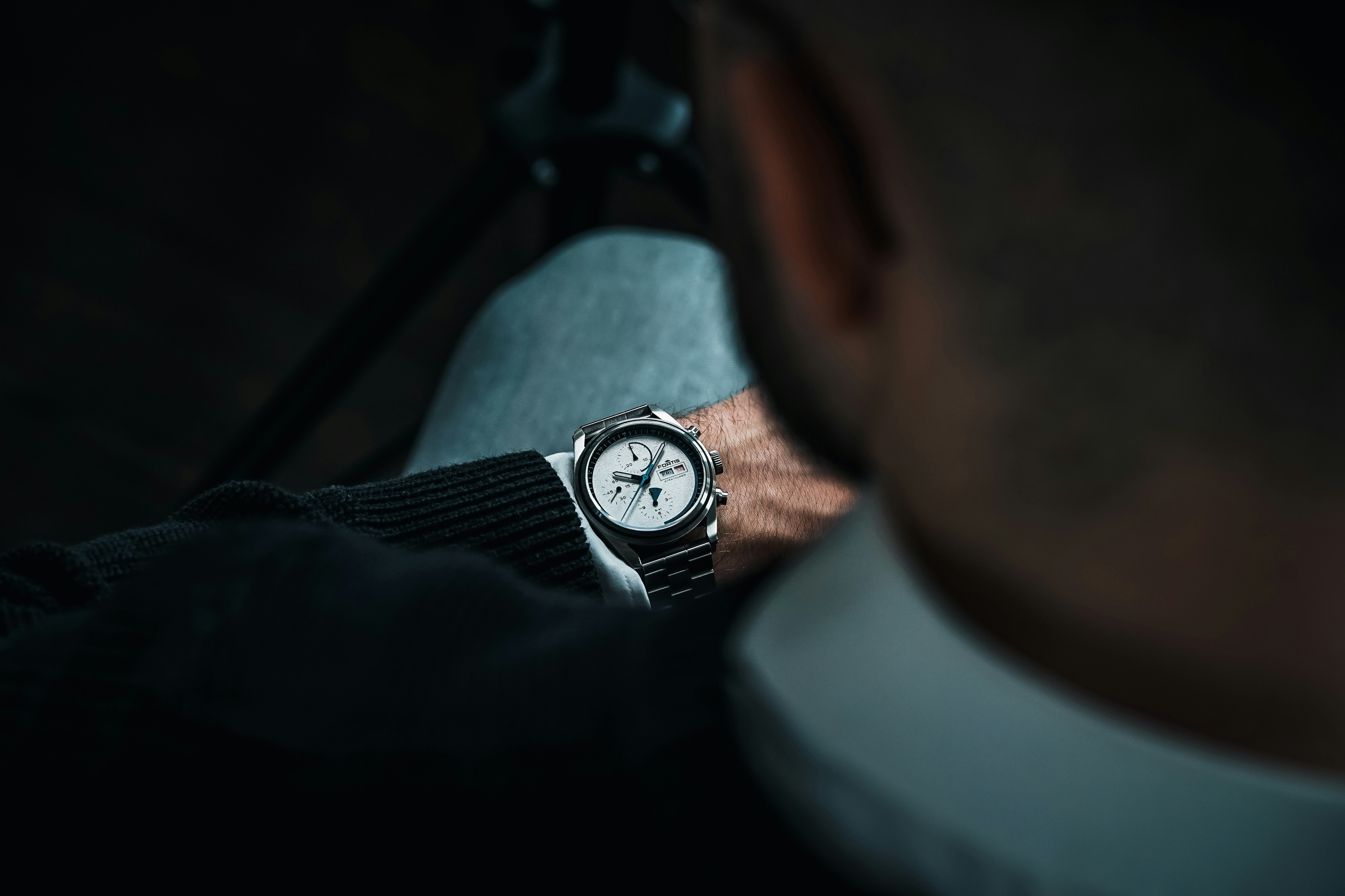 a man with a watch on his wrist, 