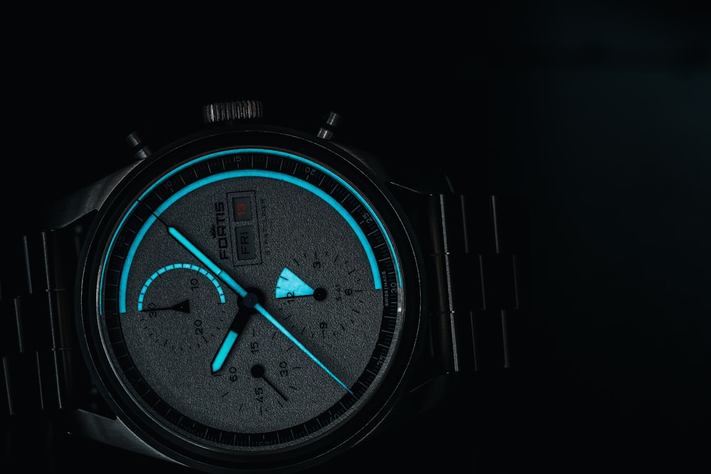 a close up of a watch in the dark