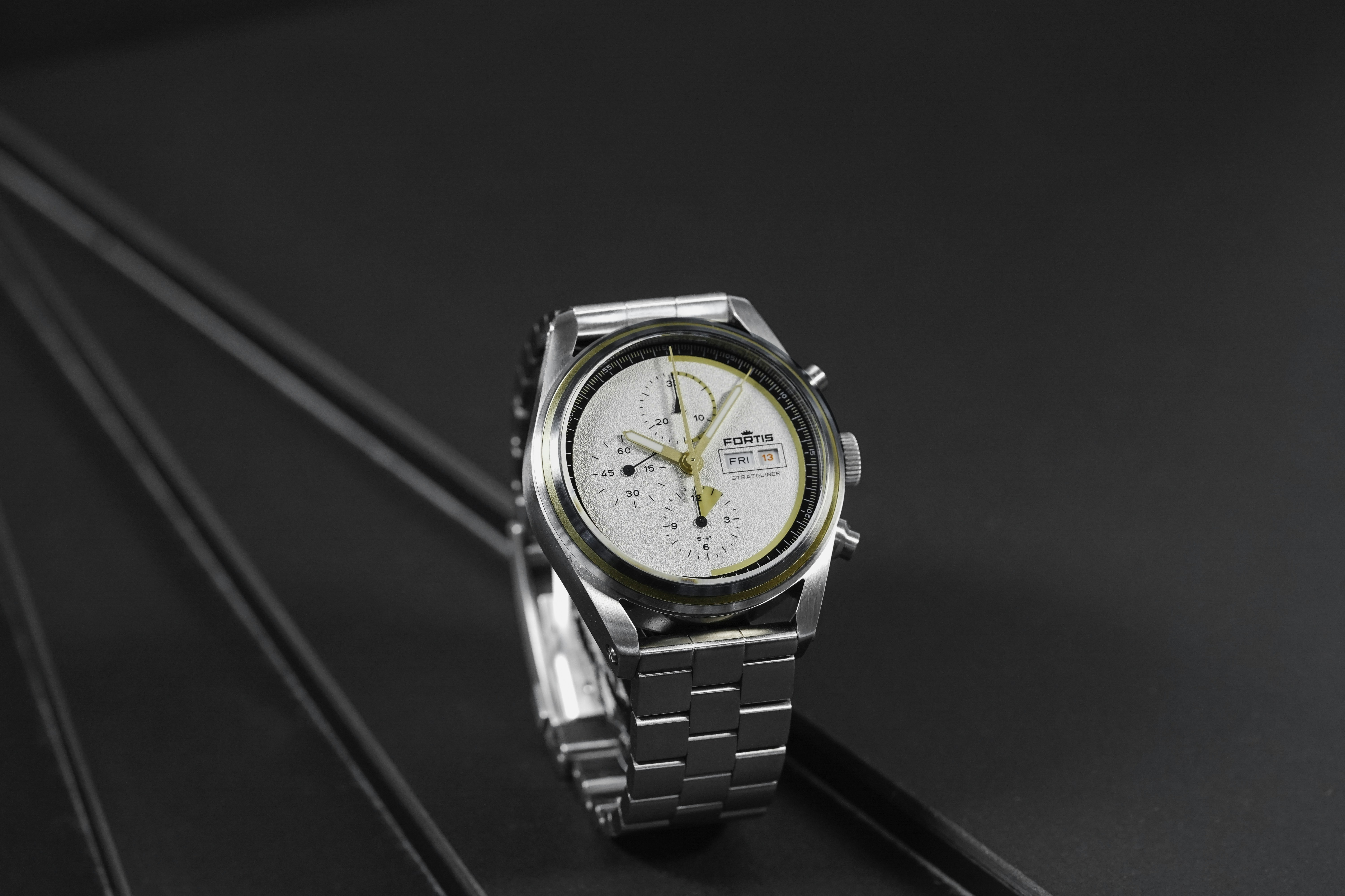 Gold luxury watch on black table