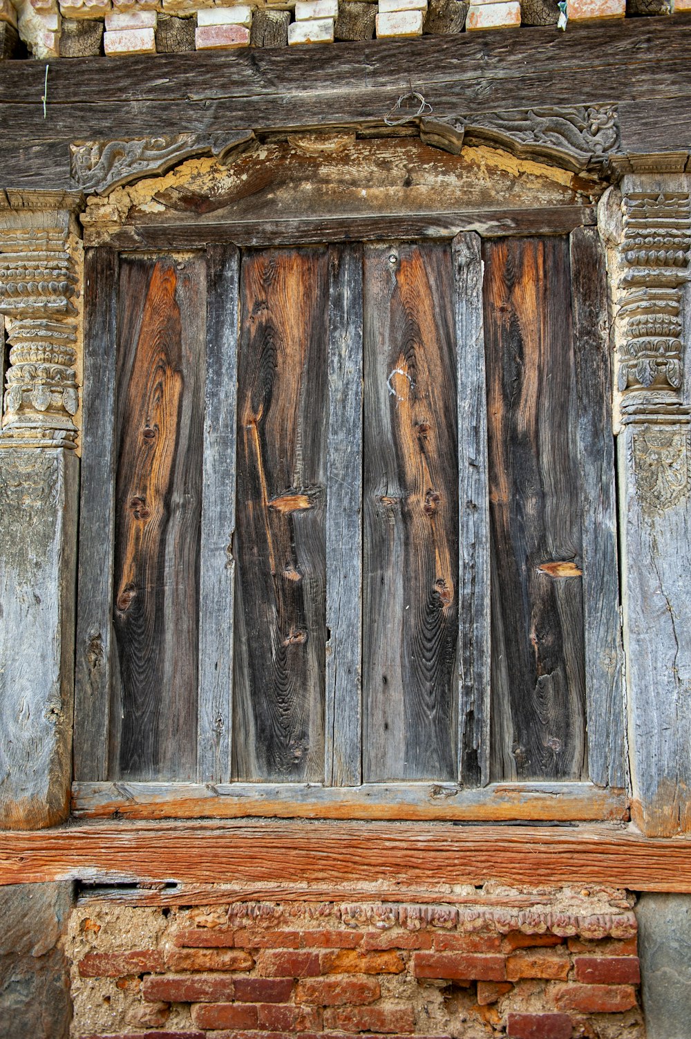 a close up of a wooden door on a building