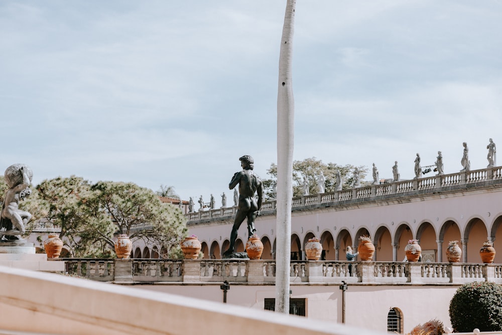 a statue of a man standing on top of a building