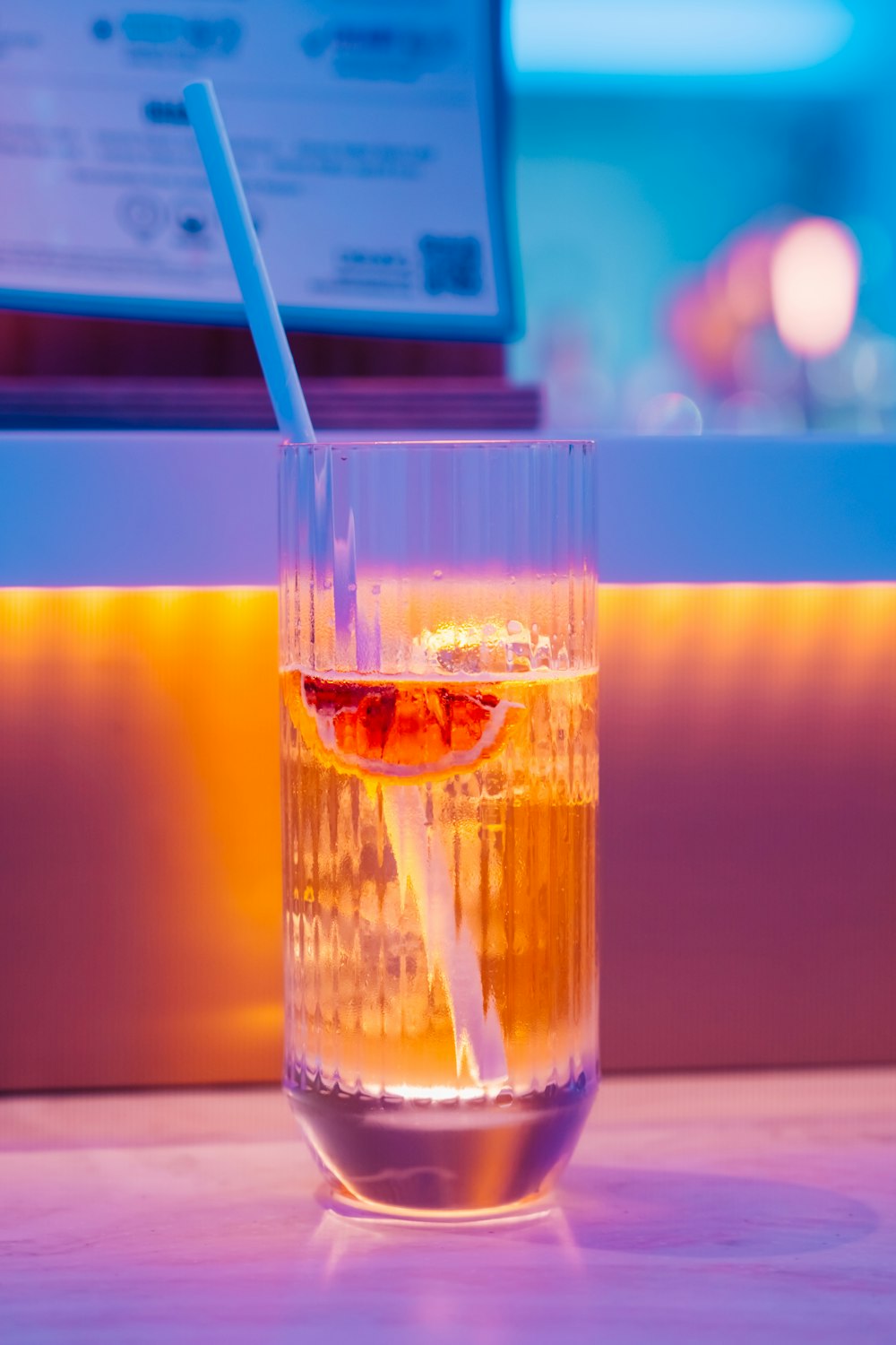 a glass filled with liquid sitting on top of a table