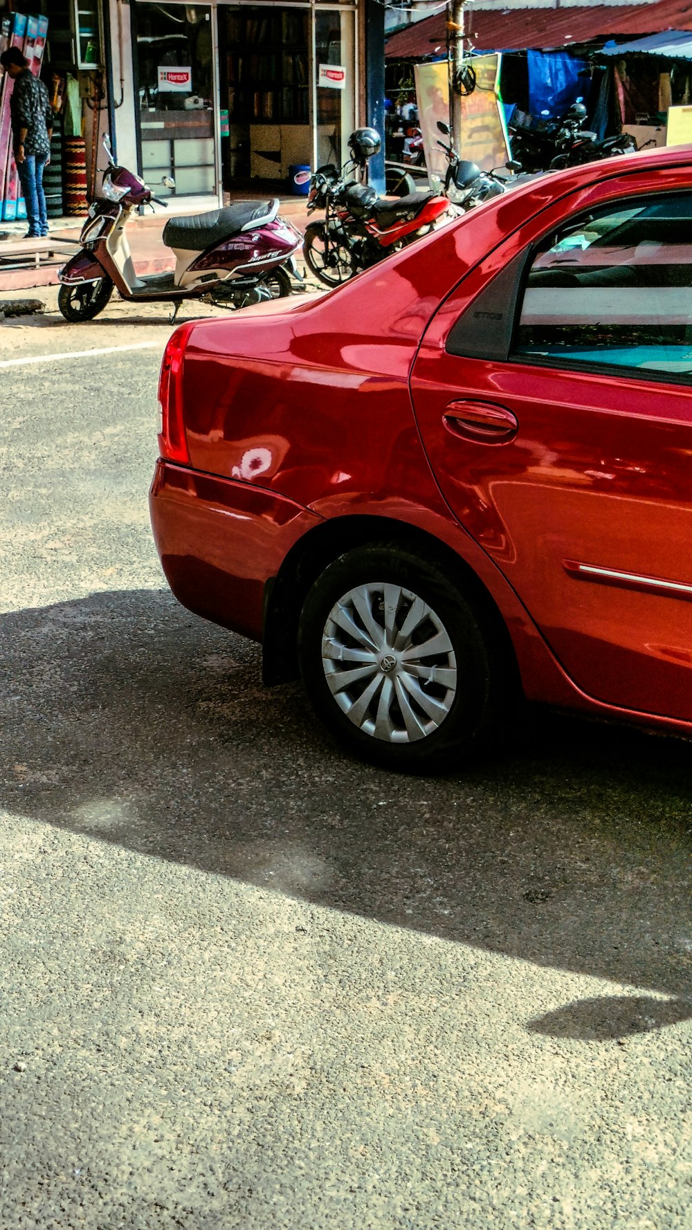 a red car parked on the side of the road