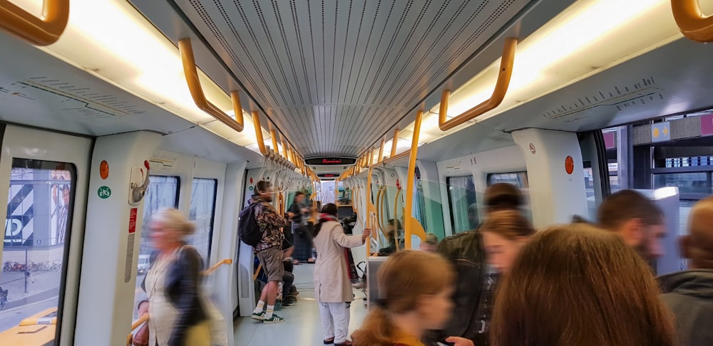 a group of people standing on a subway train