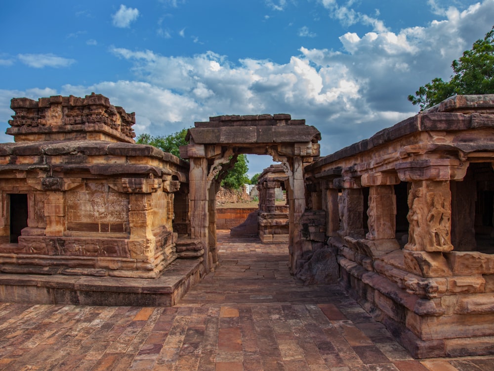 a group of stone structures sitting on top of a brick floor