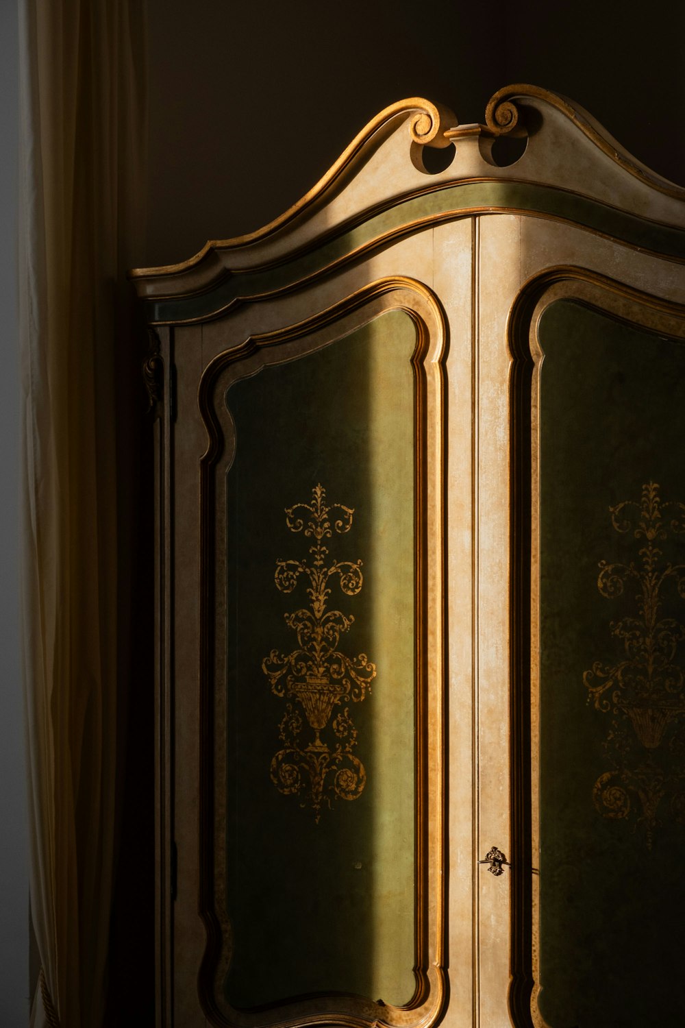 a gold and black armoire with ornate designs