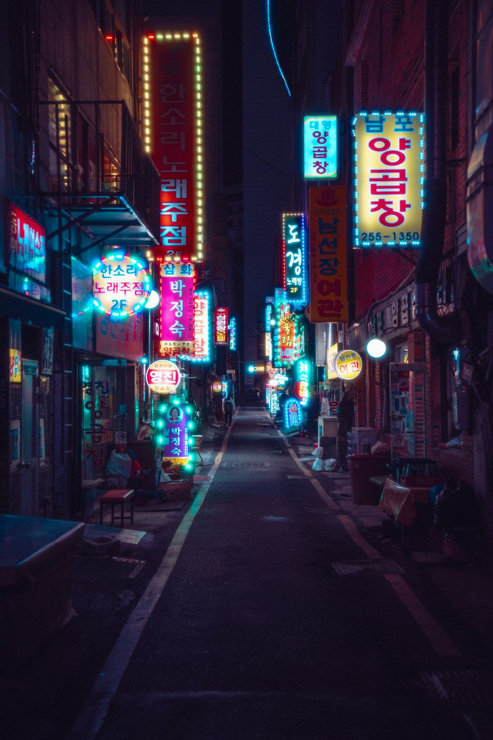 a city street filled with lots of neon signs