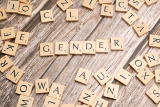 a close up of scrabble letters on a wooden surface