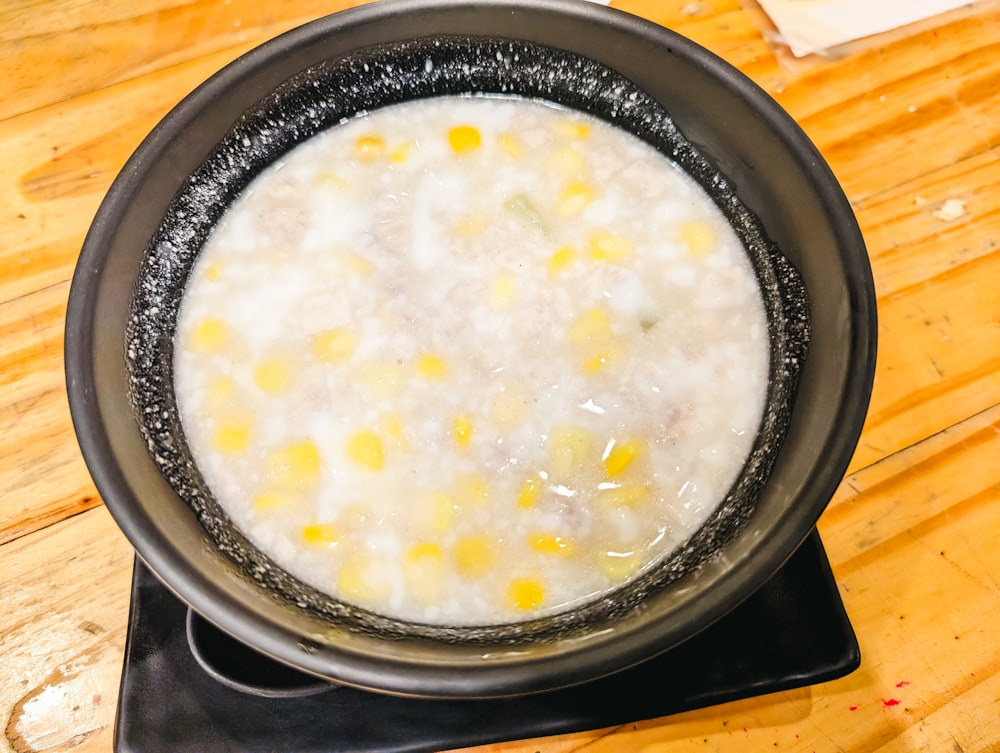 a bowl of food sitting on top of a wooden table