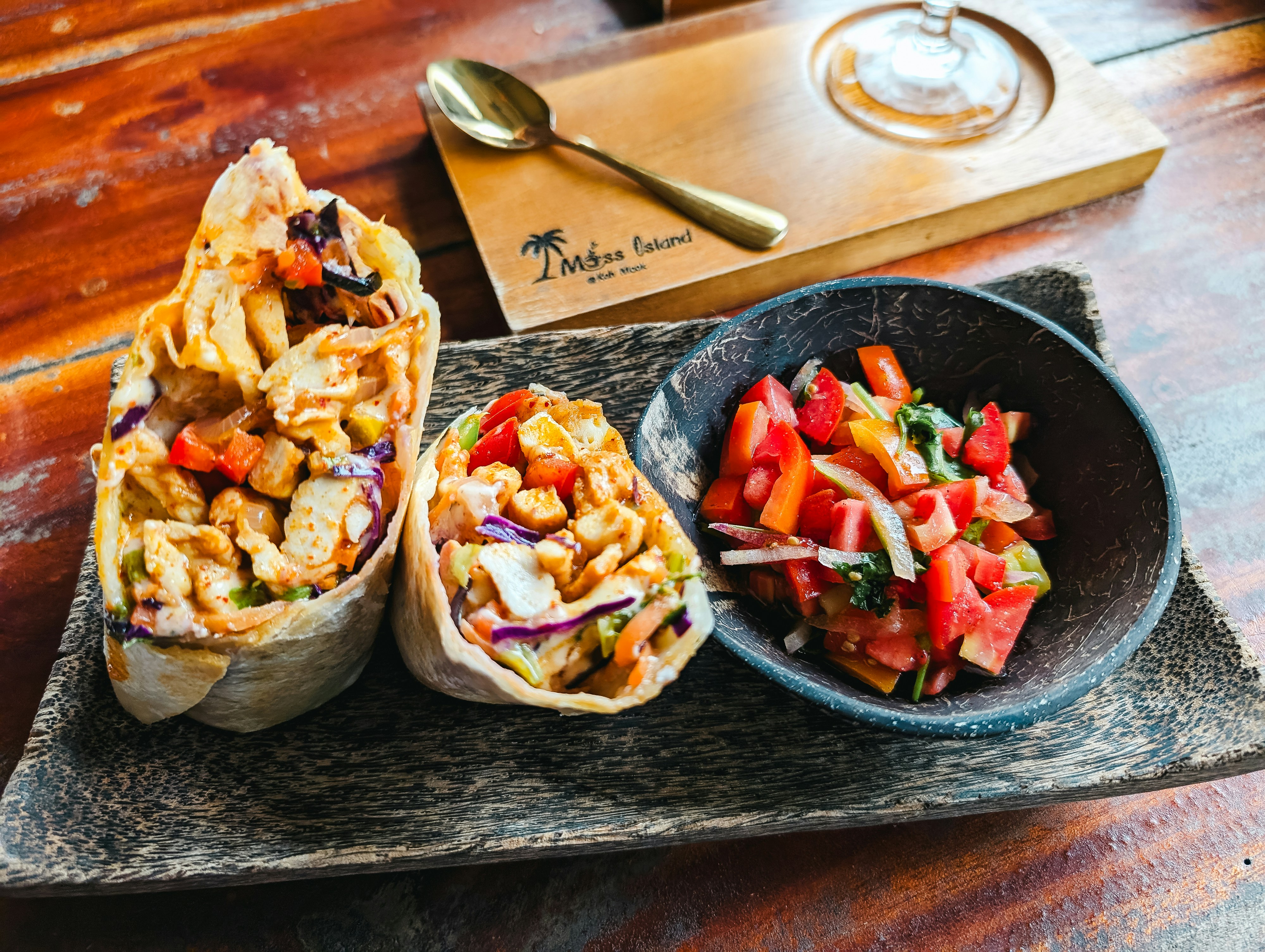 Wraps with salsa on a wooden table