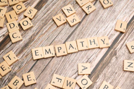 scrabble tiles spelling the word sympathy on a wooden surface