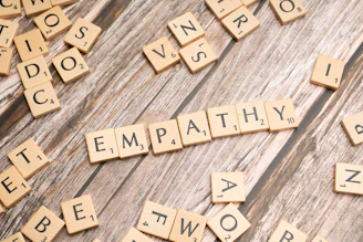 scrabble tiles spelling the word sympathy on a wooden surface