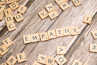 scrabble tiles spelling the word sympathy on a wooden surface