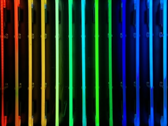a row of multicolored radiators in front of a black background