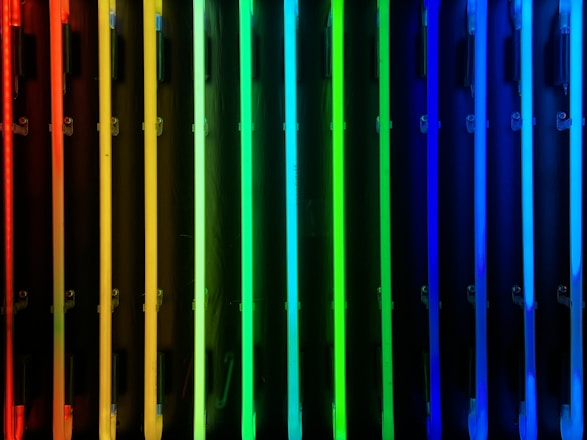 a row of multicolored radiators in front of a black background