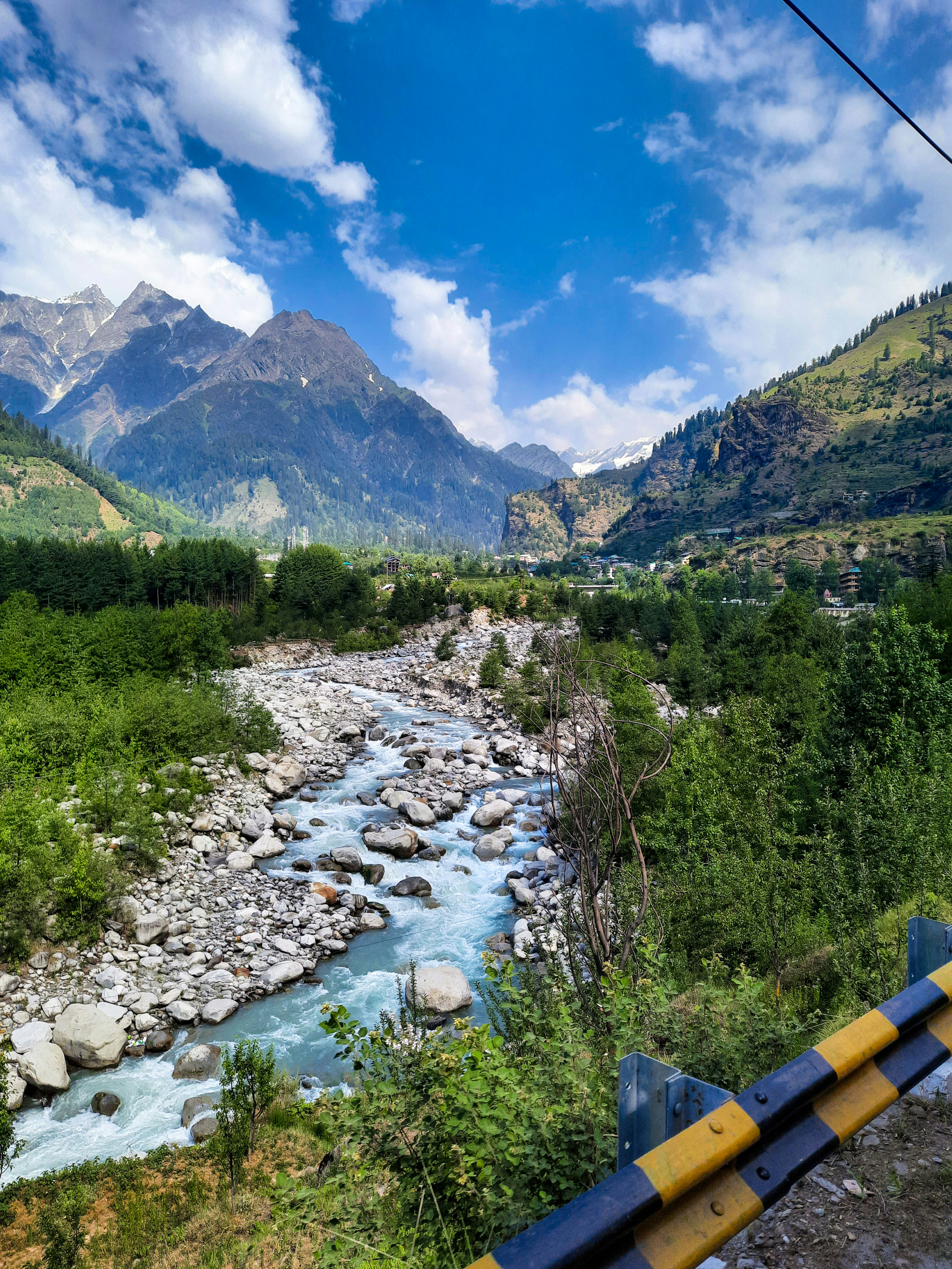 a river running through a lush green valley
