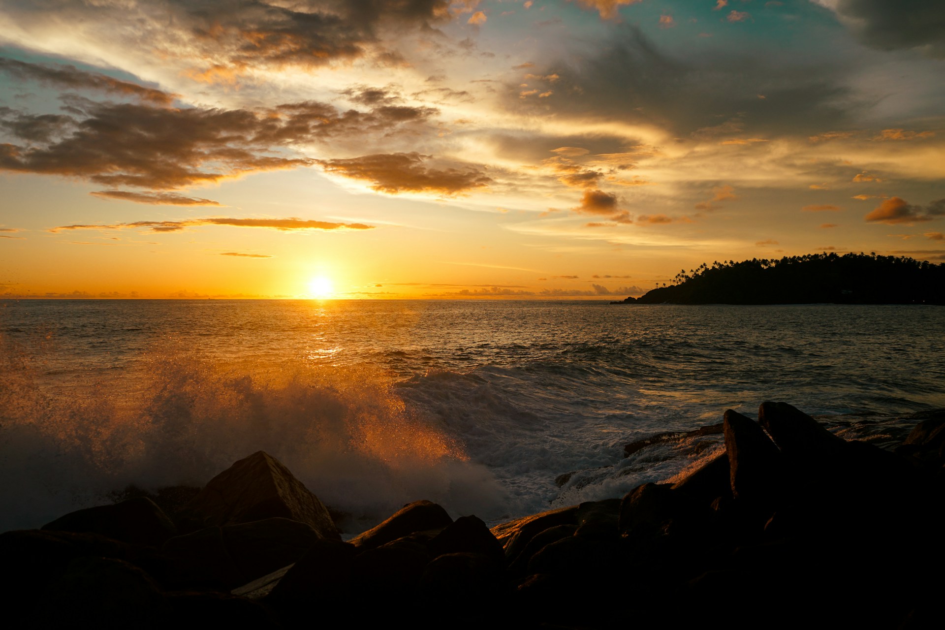 the sun is setting over the ocean with waves