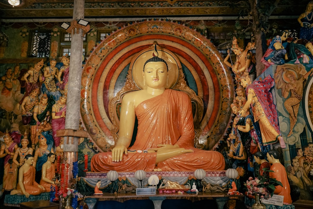 a large buddha statue sitting in front of a wall