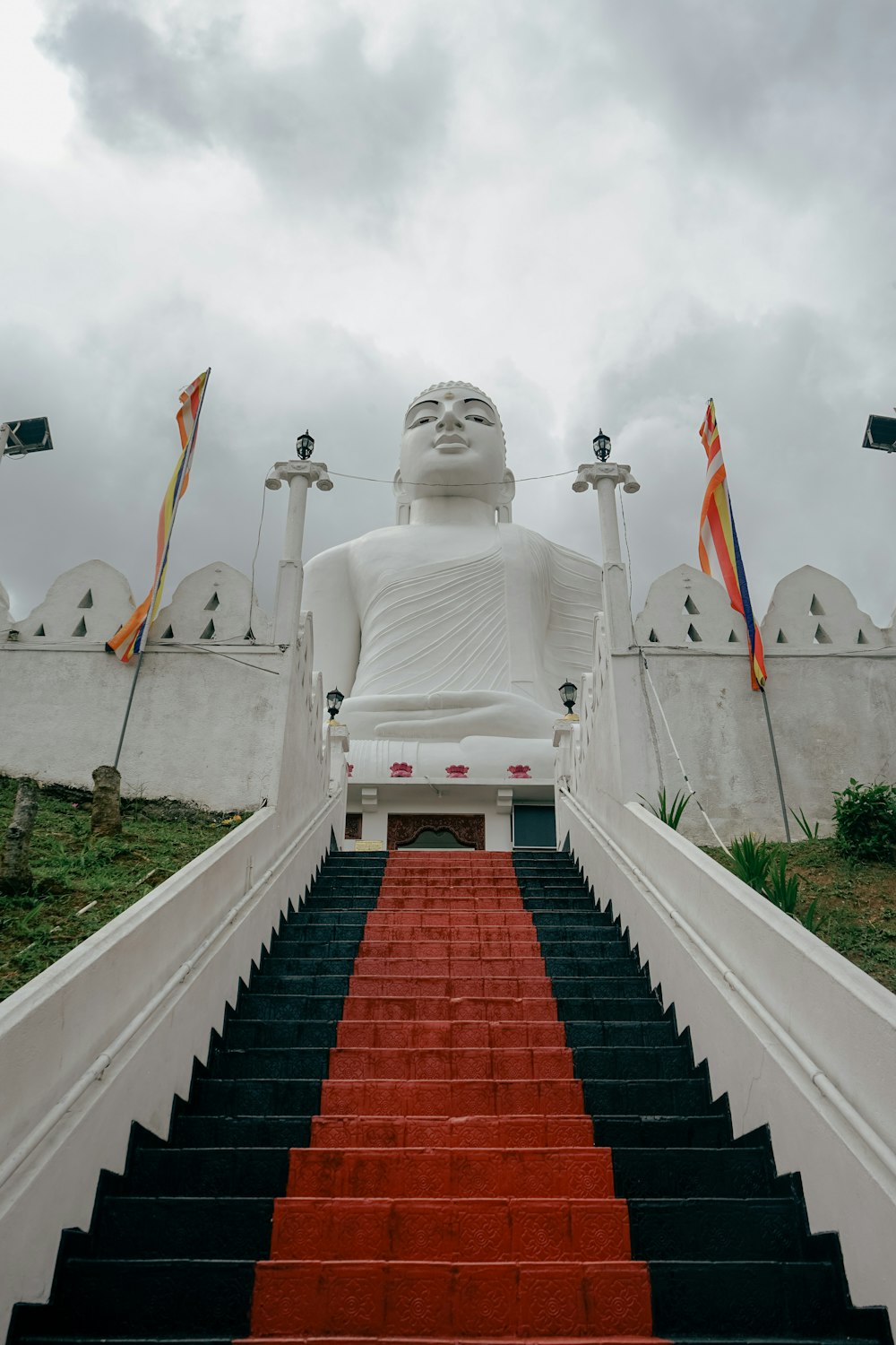 a giant buddha statue sitting on top of a set of stairs