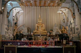 a golden buddha statue sitting in a room