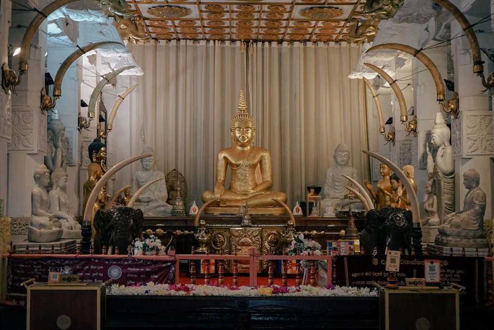 a golden buddha statue sitting in a room