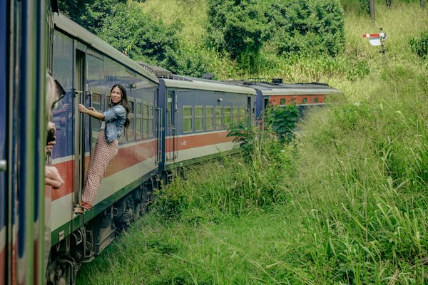 A woman standing on the side of a train — Ella, Sri Lanka