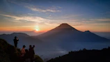 a group of people standing on top of a mountain