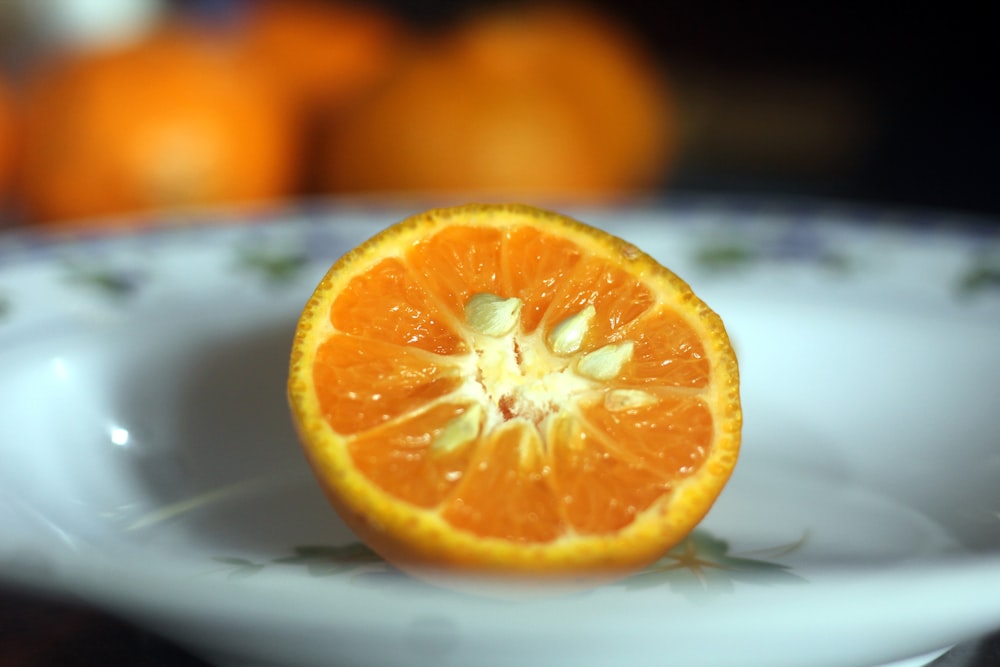 a slice of orange sitting on top of a white plate